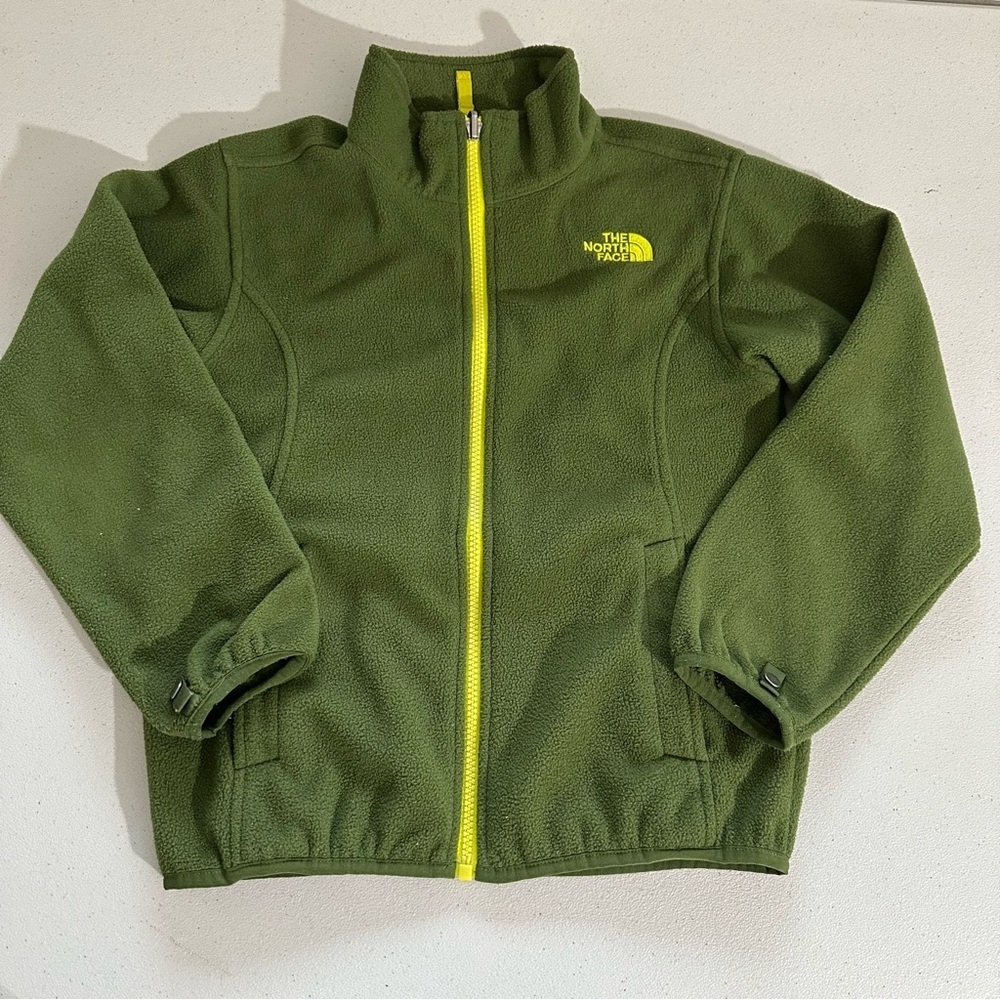 The North Face boys  full-zip fleece jacket in green with a neon yellow zipper.